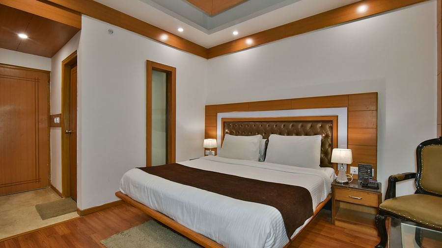 A large bed in Luxury Room Without Balcony at DLS Highland Resort and Spa, Mussoorie.